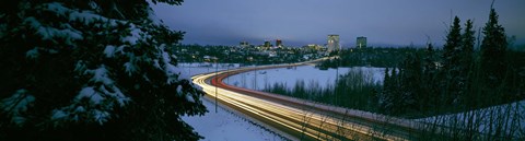 Framed Autumobile lights on busy street, distant city lights, frozen Westchester Lagoon, Anchorage, Alaska, USA. Print