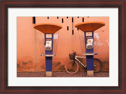 Framed Public telephone booths in front of a wall, Morocco Print