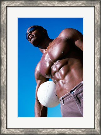 Framed Low angle view of a young man holding a volleyball Print