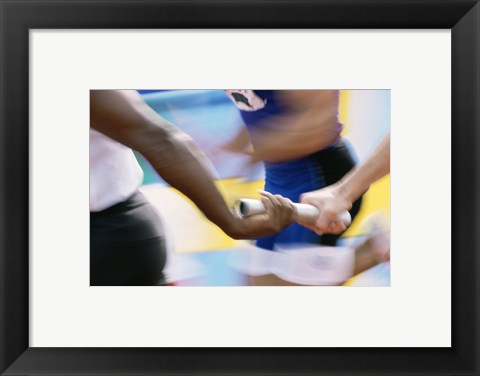 Framed Mid section view of runners exchanging baton at a relay race Print