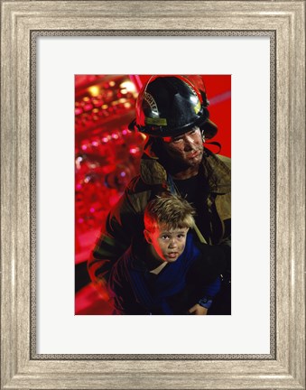 Framed Close-up of a firefighter carrying a boy Print