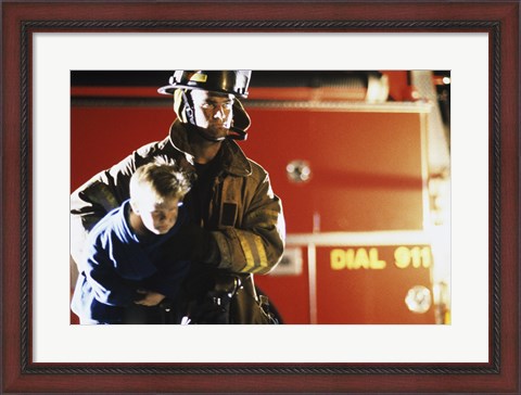 Framed Close-up of a firefighter carrying a boy Print