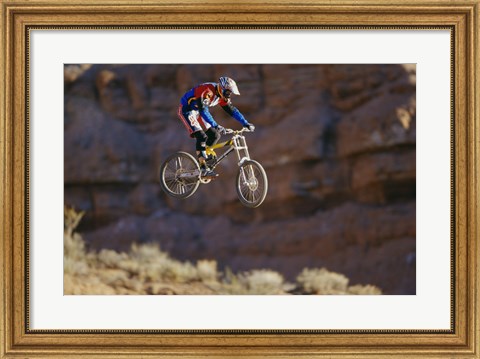 Framed Side profile of a person on a bicycle in mid air Print