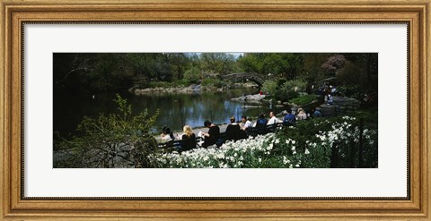 Framed Group of people sitting on benches near a pond, Central Park, Manhattan, New York City, New York State, USA Print