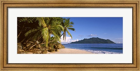 Framed Palm trees grow out over a small beach with Silhouette Island in the background, Seychelles Print