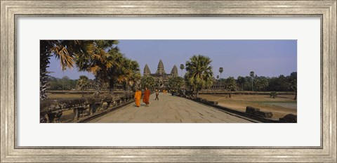 Framed Two monks walking in front of an old temple, Angkor Wat, Siem Reap, Cambodia Print