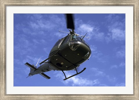 Framed Former US Air Force Bell UH-1E Huey helicopter in flight Print