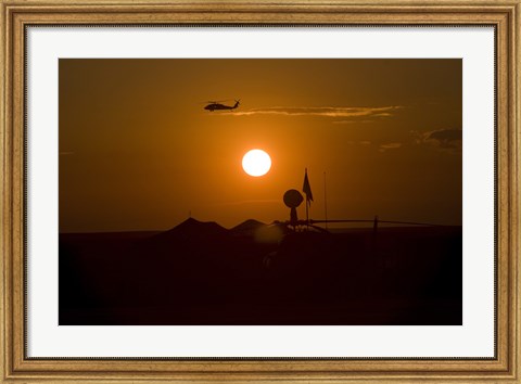 Framed UH-60 Blackhawk Flies Over Camp Speicher Airfield at Sunset Print