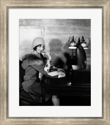 Framed 1920s  Woman With Pen To Lips Wearing Cloche Hat Print