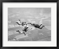 Framed Three Men Holding Hands Sky Diving