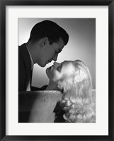 Framed Movie Star Studio Style Romantic Couple Embracing On Sofa About To Kiss