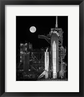 Framed Space Shuttle Discovery Sits Atop the Launch Pad With a Full Moon in Background