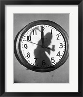 Framed Close-up of the shadow of a person carrying a scythe on a clock