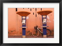 Framed Public telephone booths in front of a wall, Morocco