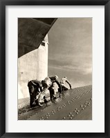 Framed Three construction workers putting a coat of paint on a slanted wall of riveted-steel plates on the Hoover Dam spillway