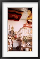 Framed Young Girl Praying in Front of a Giant Buddha Statue