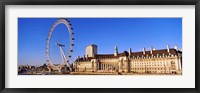 Framed Ferris wheel with buildings at the waterfront, River Thames, Millennium Wheel, London County Hall, London, England