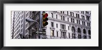 Framed Low angle view of a Red traffic light in front of a building, Wall Street, New York City