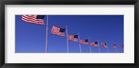 Framed Low angle view of American flags, Washington Monument, Washington DC, USA