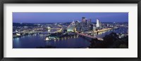 Framed Buildings along a river lit up at dusk, Monongahela River, Pittsburgh, Allegheny County, Pennsylvania, USA