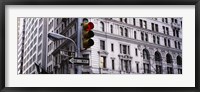 Framed Low angle view of a Red traffic light in front of a building, Wall Street, New York City