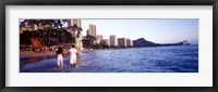 Framed Rear view of a couple wading on the beach, Waikiki Beach, Honolulu, Oahu, Hawaii, USA