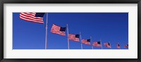 Framed Low angle view of American flags, Washington Monument, Washington DC, USA