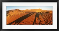 Framed Shadows of camel riders in the desert at sunset, Sahara Desert, Morocco