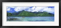 Framed Polynesian people rowing a yellow outrigger boat in the bay, Opunohu Bay, Moorea, Tahiti, French Polynesia