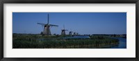 Framed Traditional windmills at a riverbank, Kinderdijk, Rotterdam, Netherlands