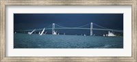 Framed Storm approaches sailboats racing past Rose Island lighthouse and Newport Bridge in Narragansett Bay, Newport, Rhode Island USA