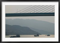 Framed Container ships passing a newly constructed bridge on the Yangtze River, Wanzhou, Chongqing Province, China