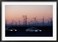 Framed Cars moving on road with wind turbines in background at dusk, Palm Springs, Riverside County, California, USA