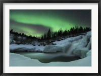 Framed wintery waterfall and aurora borealis over Tennevik River, Norway