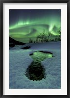 Framed Aurora Borealis over a frozen river, Norway