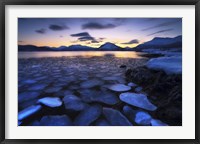 Framed Ice flakes drifting against the sunset in Tjeldsundet strait, Troms County, Norway