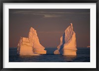 Framed Antarctic Peninsula, icebergs at midnight sunset.