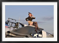 Framed Pin-up girl sitting on the wing of a P-51 Mustang