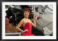 Framed Redhead pin-up girl in 1940's style dancer attire holding on to a vintage aircraft propeller