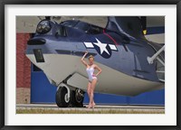 Framed pin-up girl posing with a Catalina seaplane