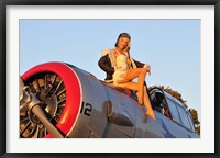 Framed 1940's style aviator pin-up girl posing with a vintage T-6 Texan aircraft