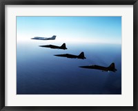 Framed Three F-5E Tiger IIs fly in formation with a Learjet 25