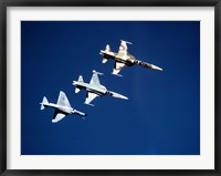 Framed Two F-5 Tiger II's and an A-4E Skyhawk in flight above the Pacific Ocean