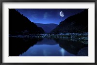 Framed Moon rising over tranquil lake and forest against starry sky, Bulgaria