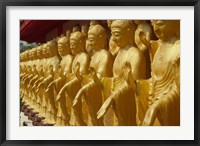 Framed Taiwan, Foukuangshan Temple, Standing gold-colored Buddha statues at a Buddhist shrine