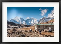 Framed Trekkers and yaks in Lobuche on a trail to Mt Everest