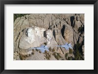 Framed Two F/A-18E Super Hornets conduct a fly by of Mount Rushmore